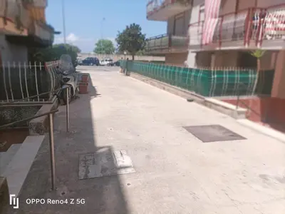 a street with a bench on the side of a building at Case D'irene in Capaci