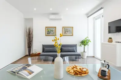 a living room with a glass table and a couch at Old Port Luxury Apartments in Palermo