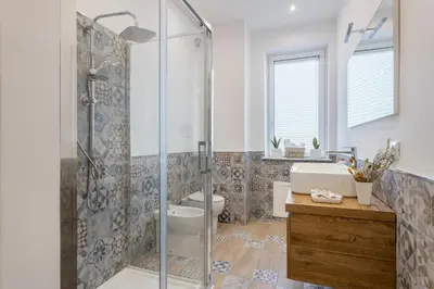 a bathroom with a shower and a toilet and a sink at Old Port Luxury Apartments in Palermo