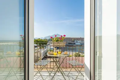 a view from a balcony with a table and chairs at Old Port Luxury Apartments in Palermo