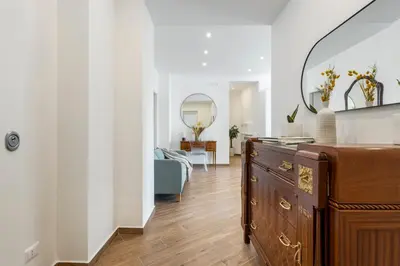 a living room with a wooden dresser and a blue couch at Old Port Luxury Apartments in Palermo