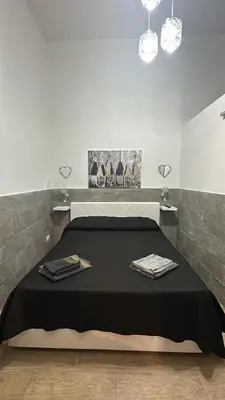 a bed in a room with two towels on it at La casetta del centro in Palermo