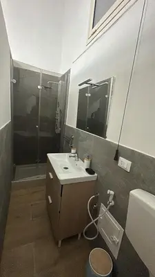 a bathroom with a sink and a shower at La casetta del centro in Palermo