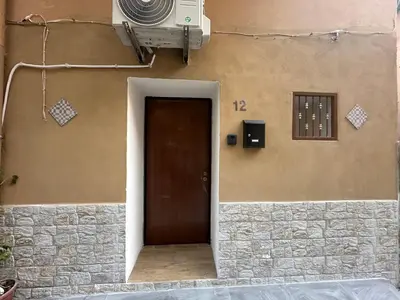 a door leading to a building with a wall at La casetta del centro in Palermo