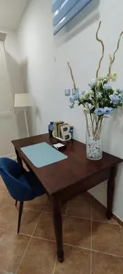 a wooden table with a vase of flowers on it at Casa Renda in Balestrate