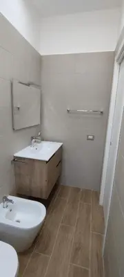 a white bathroom with a sink and a toilet at Casa Renda in Balestrate