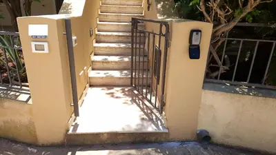a gate leading up to a set of stairs at Triskelia in San Vito lo Capo