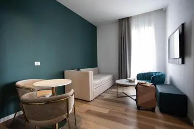 a living room with a couch and a table at Mondello Glam Hotel & Terrace in Mondello
