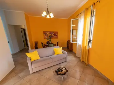 a living room with yellow walls and a couch at Stella Maris Case Vacanze in Balestrate