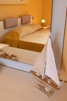 a model of a bedroom with a sailboat in a mirror at Stella Maris Case Vacanze in Balestrate