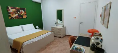 a bedroom with a bed and a green wall at Casa Renda in Balestrate