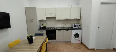 a kitchen with a sink and a washing machine at Casa Renda in Balestrate