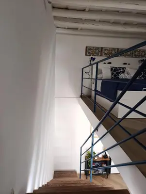 a bedroom with two bunk beds and a staircase at Liberty Blue House in Palermo