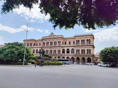 a large building with a person walking in front of it at Liberty Blue House in Palermo