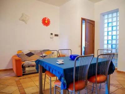 a dining room with a blue table and chairs at Casa del pescatore Appartment -By Rentalbeb italy- in Palermo