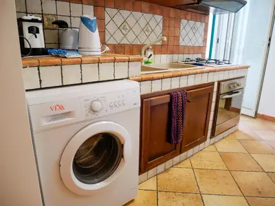a kitchen with a washing machine and a sink at Casa del pescatore Appartment -By Rentalbeb italy- in Palermo