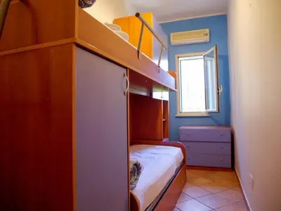 a small bedroom with a bunk bed and a window at Casa del pescatore Appartment -By Rentalbeb italy- in Palermo