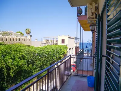 a balcony of a house with a view of the ocean at Casa del pescatore Appartment -By Rentalbeb italy- in Palermo