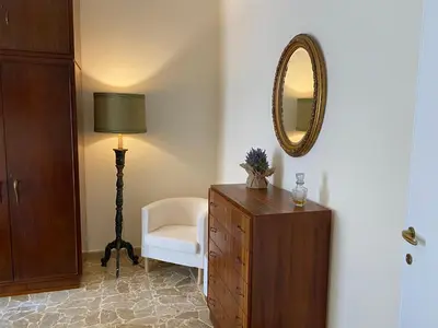 a room with a dresser and a mirror and a chair at Casa Verdura in Palermo