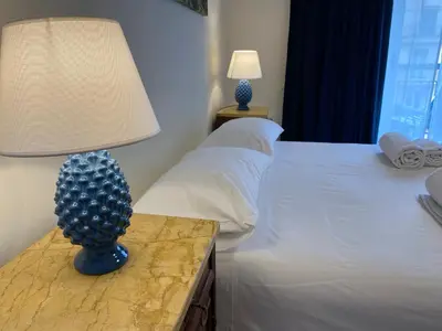 a bedroom with a bed and a lamp on a table at Casa Verdura in Palermo