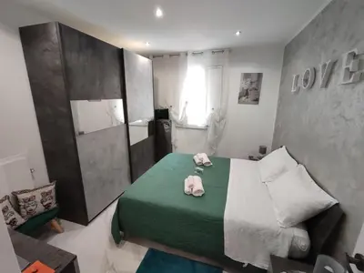 a bedroom with a green bed with towels on it at La casetta di Davide in Palermo