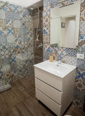 a bathroom with a sink and a mirror at L'angolo di Leo in Isola delle Femmine