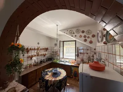 an archway in a kitchen with a table at Villa Shanti a Romitello - 