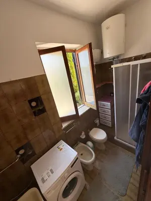 a small bathroom with a toilet and a sink at Villa Shanti a Romitello - 