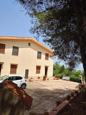 a white car parked in front of a building at Villa Shanti a Romitello - 