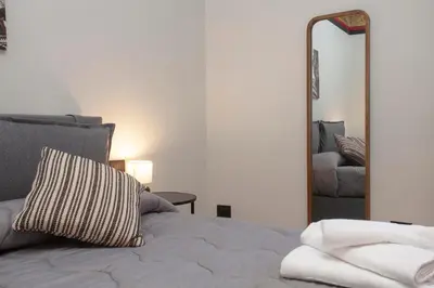 a bedroom with a bed and a large mirror at Sella Apartment Centro Storico in Palermo