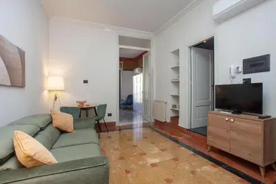 a living room with a green couch and a flat screen tv at Sella Apartment Centro Storico in Palermo