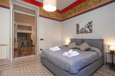 a bedroom with a large bed with two towels on it at Sella Apartment Centro Storico in Palermo