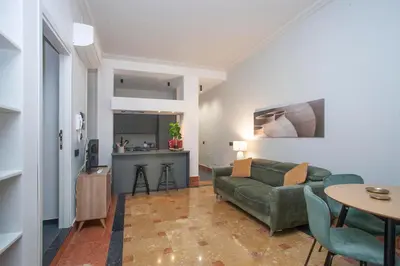 a living room with a green couch and a table at Sella Apartment Centro Storico in Palermo