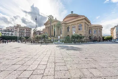a large building in a plaza in front of a building at Il Cortile degli Aragonesi by Wonderful Italy in Palermo