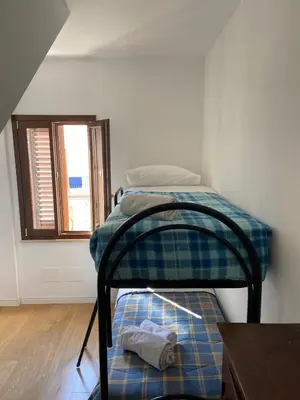 a room with two bunk beds in a room at marinellahomeandsea in Palermo