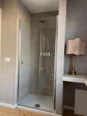 a shower with a glass door in a bathroom at marinellahomeandsea in Palermo