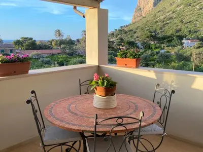 a table on the balcony with a view of the mountains at marinellahomeandsea in Palermo