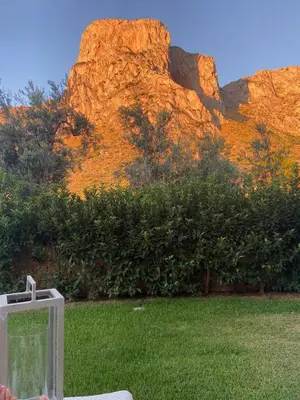 a view of a mountain with a box in the grass at marinellahomeandsea in Palermo