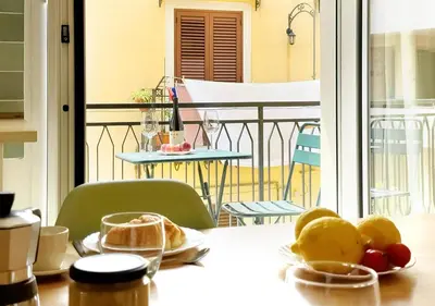 a table with plates of food on top of a balcony at Solemar Sicilia - Casa Minerva in Santa Flavia