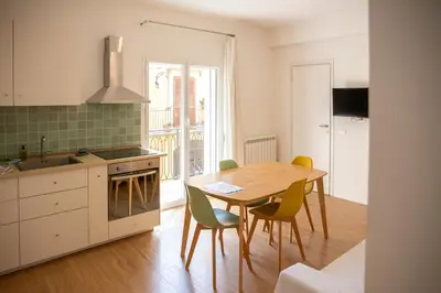 a kitchen with a table and chairs and a dining room at Solemar Sicilia - Casa Minerva in Santa Flavia