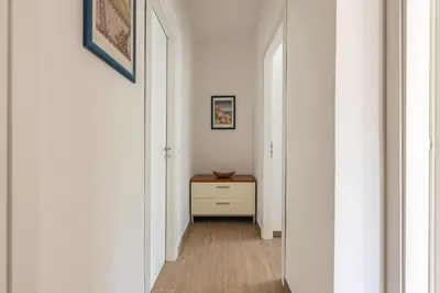 a hallway with white walls and a wooden floor at La Casetta Donna Vita a Mondello by Wonderful Italy in Palermo