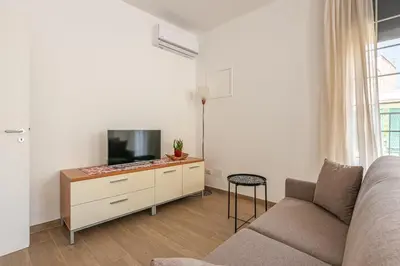 a living room with a couch and a flat screen tv at La Casetta Donna Vita a Mondello by Wonderful Italy in Palermo