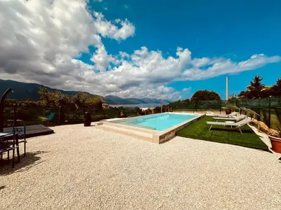 a swimming pool in a yard with a table and chairs at Casa Sole eventi, Wi-Fi, fronte Mare con piscina in Alcamo