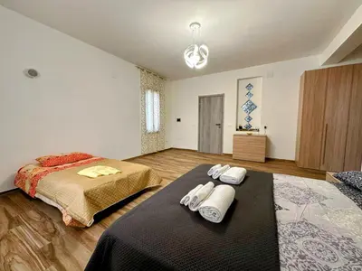a bedroom with two beds and towels on a bed sidx sidx sidx at Casa Sole eventi, Wi-Fi, fronte Mare con piscina in Alcamo
