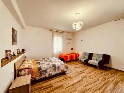 a bedroom with a bed and a couch at Casa Sole eventi, Wi-Fi, fronte Mare con piscina in Alcamo