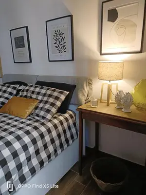 a bedroom with a bed and a table with a lamp at Suite 374 in Palermo