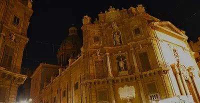 a large building with a clock tower at night at Suite 374 in Palermo