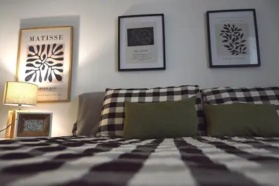 a bedroom with a bed and some pictures on the wall at Suite 374 in Palermo