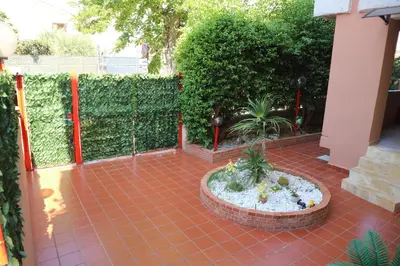 a courtyard with a fence and a potted plant at Mondello House Lemon in Palermo