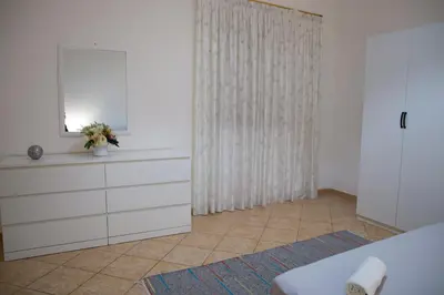 a bedroom with a white dresser and a mirror at La Casetta della Nonna in Palermo